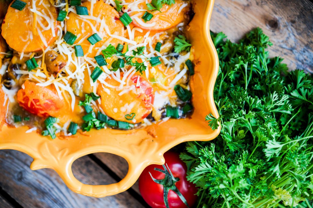 Baked vegetables in a dish on wooden background