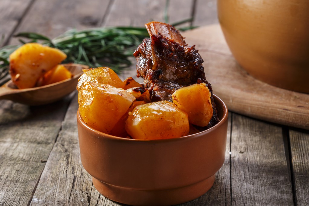 meat and potatoes baked in a pot